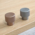 Close-up of Brass essence textured zinc alloy bar and knob handles set with modern industrial design, showing detailed surface finish.