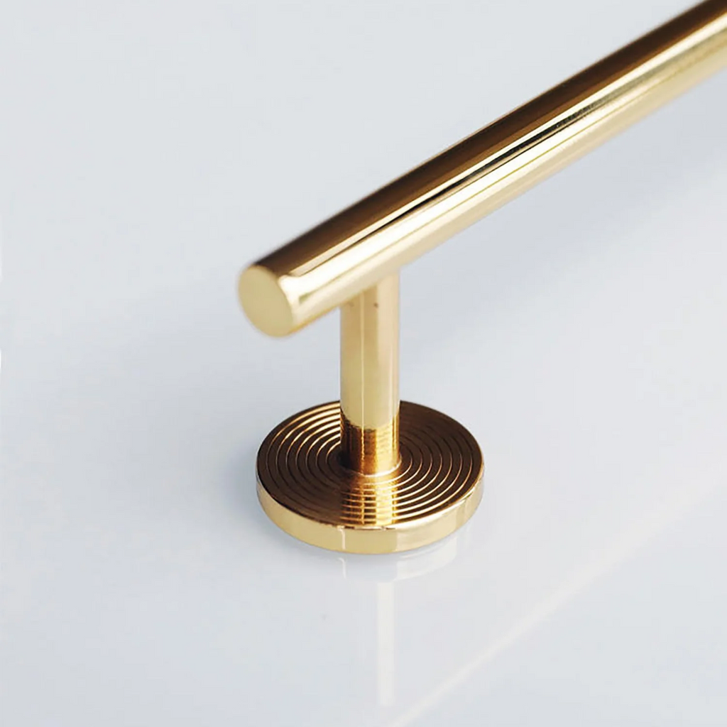 Minimalist Brass Concentric Ring Handles by Brass Essence, showing sleek gold-colored handles with concentric circle design.