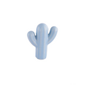 Ceramic cactus cabinet knob by Brass Essence, white with green cactus design, mounted on a wooden cabinet door.
