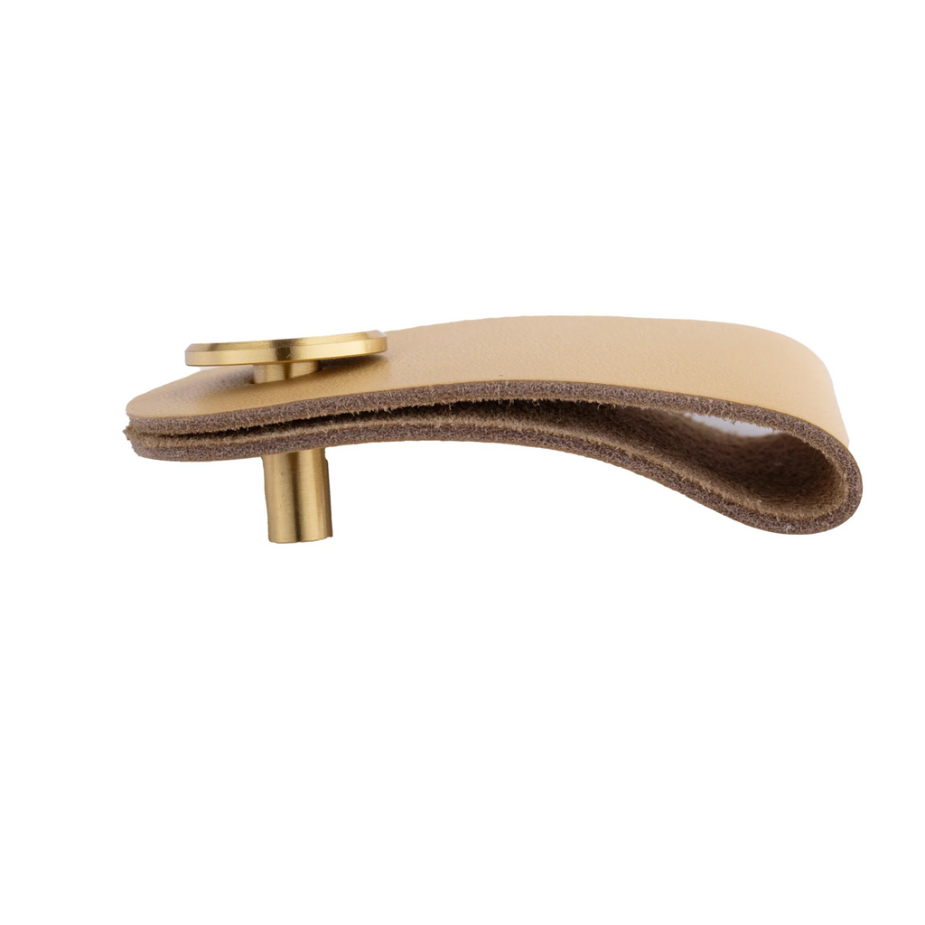 Brass essence leather and brass strap cabinet pulls with sleek design and natural leather accents on a wooden cabinet.