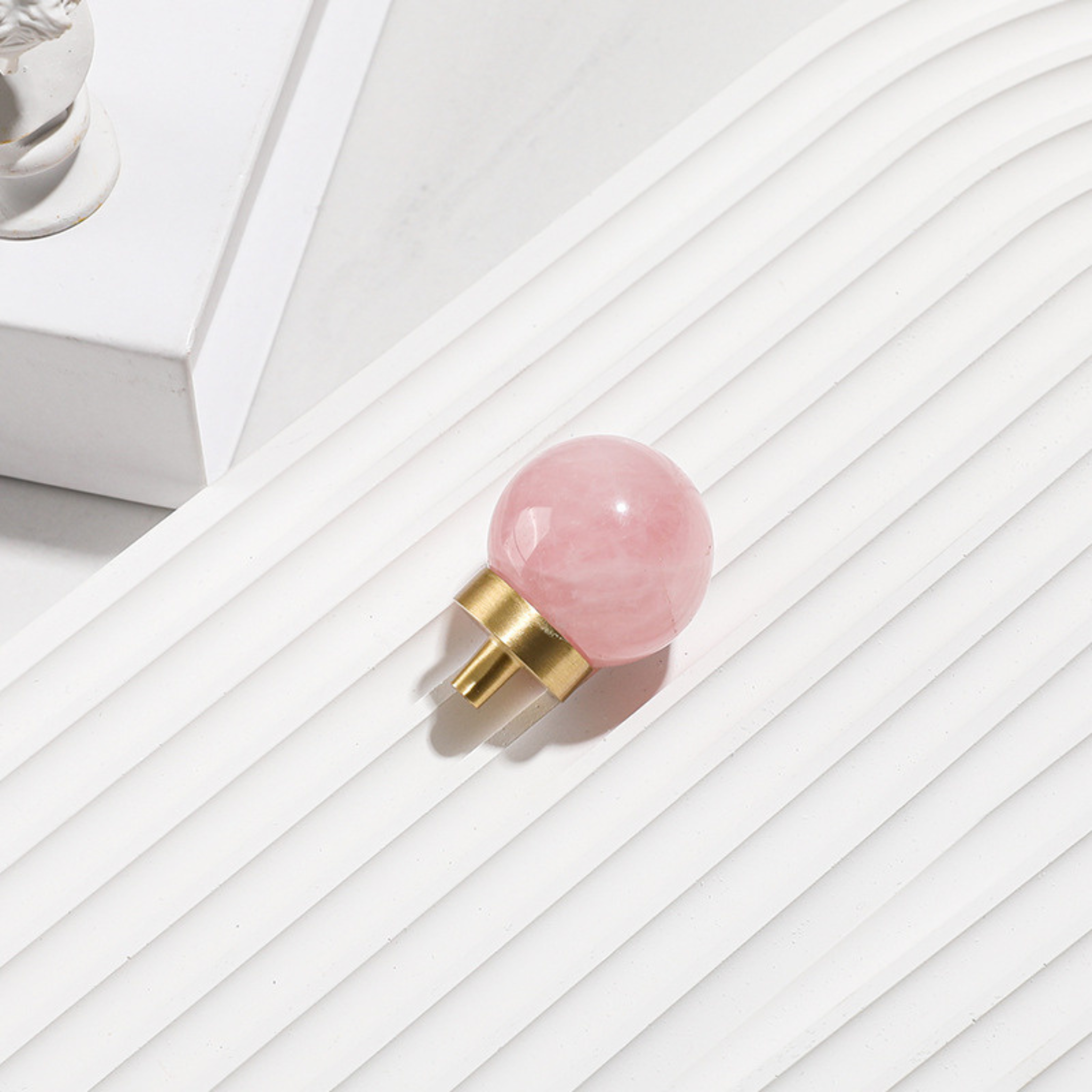 Natural crystal ball and brass cabinet knob from Brass Essence, showcasing a clear crystal sphere and polished brass finish.