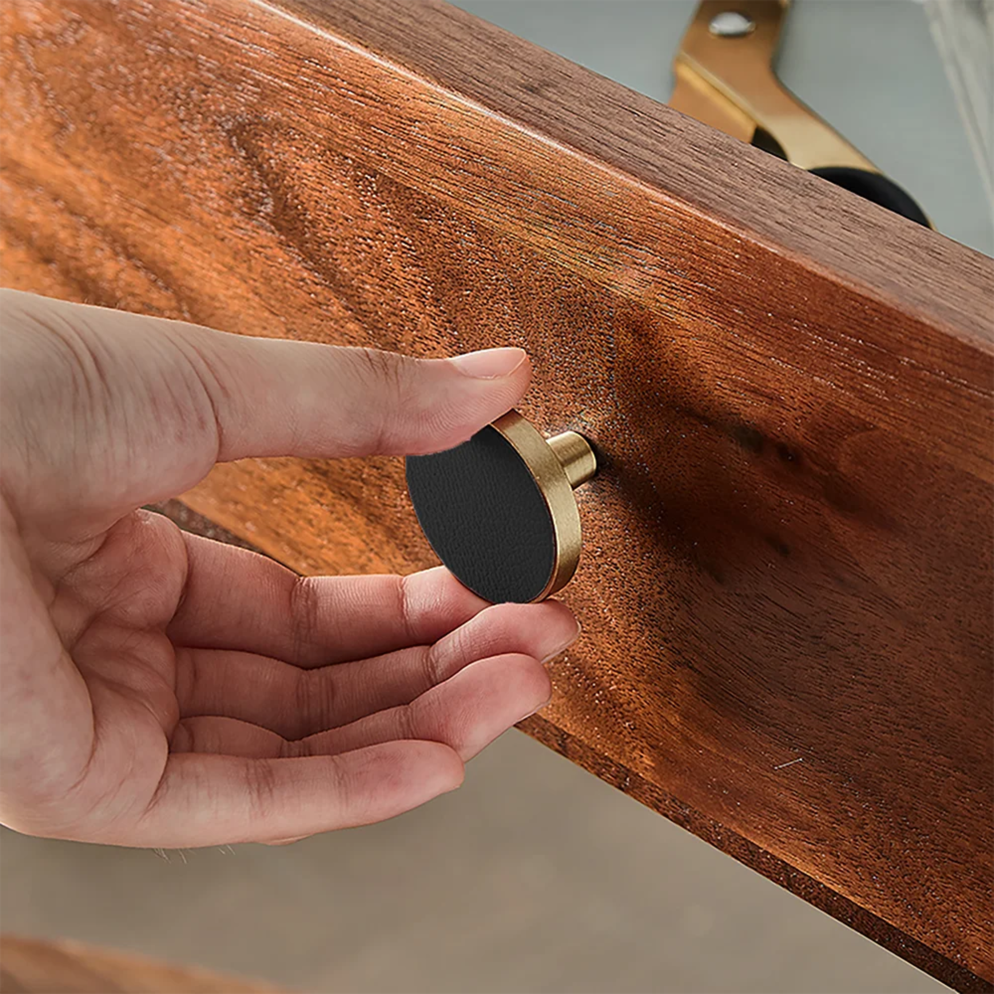 Brushed brass and leather round handle with elegant design, perfect for furniture or cabinetry from Brass Essence.