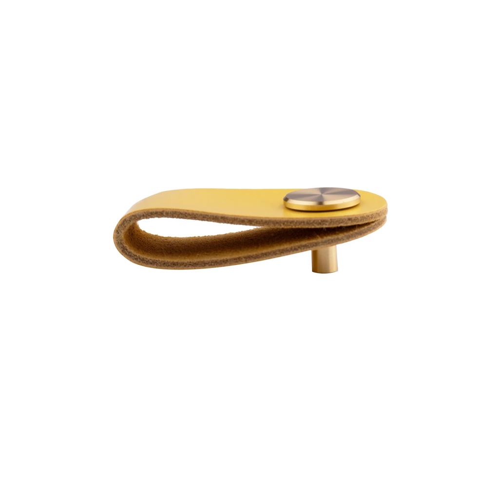 Brass Essence leather and brass strap cabinet pulls with black leather straps and brass hardware for modern cabinetry.