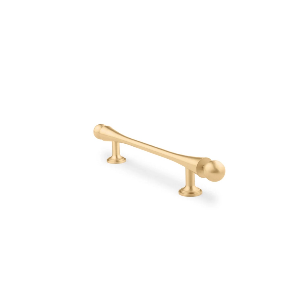 Seasaw hourglass brushed brass cabinet handle by Brass Essence, showcasing its elegant, curved design and brushed finish.
