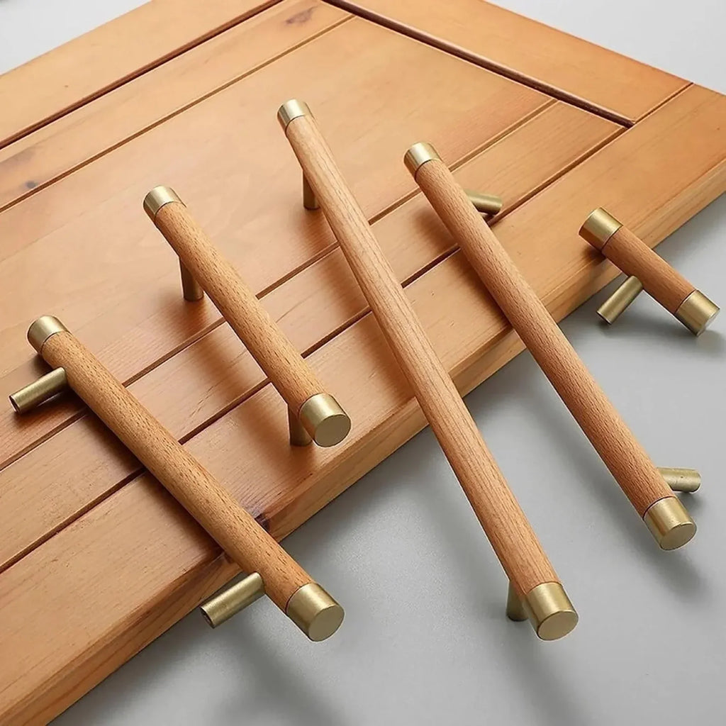 Natural wood and brass T-bar handle from Brass Essence collection, showcasing sleek design and polished finish.