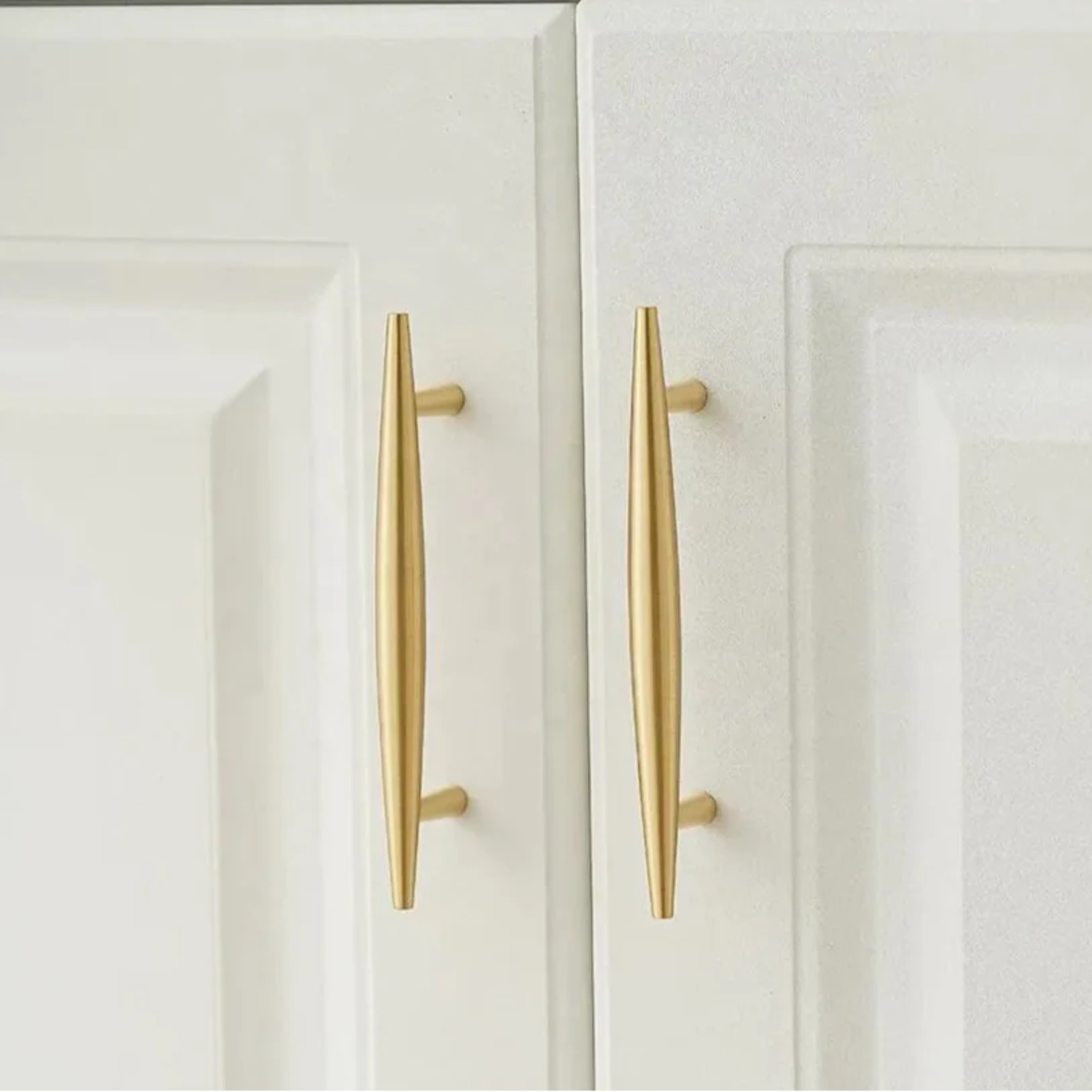Tapered brass cabinet pull from Brass Essence featuring a smooth, polished finish and ergonomic design for drawer or cabinet use.