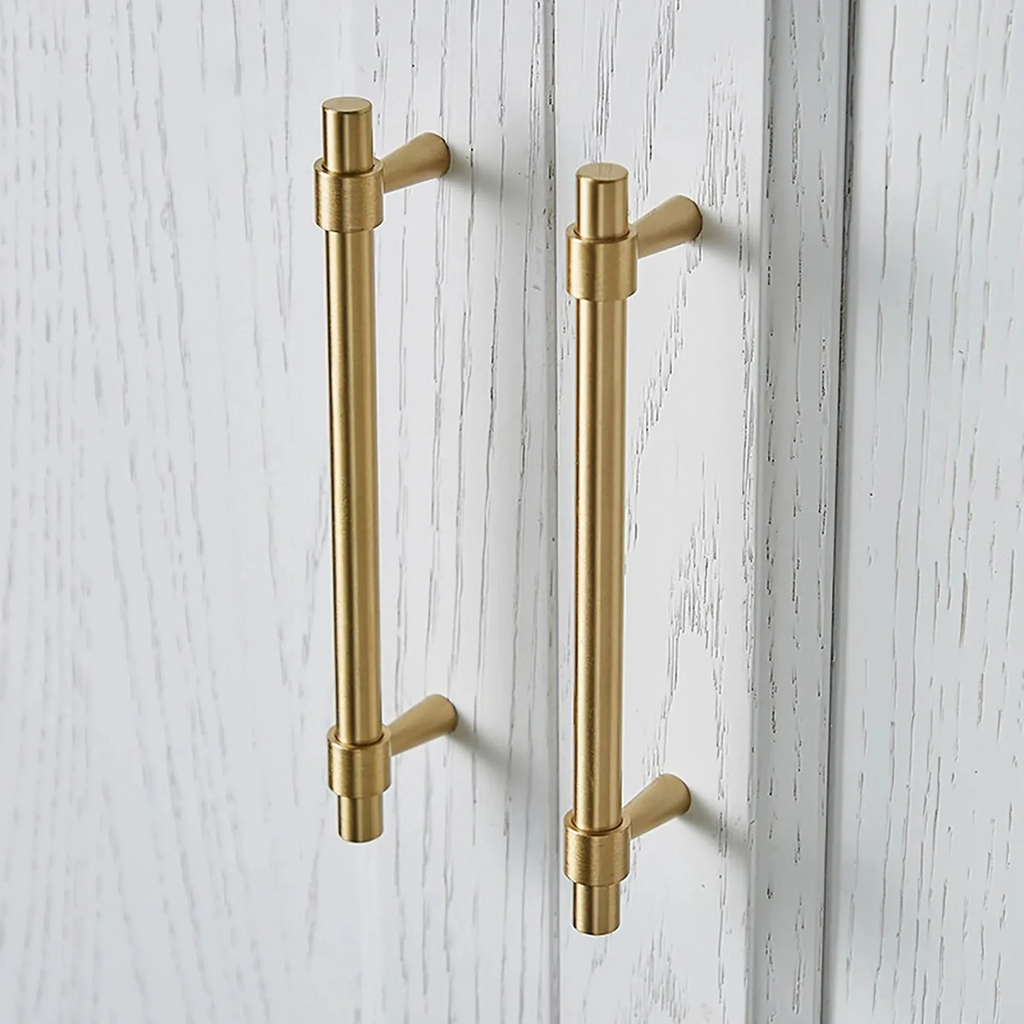Brass Essence Naveena solid brass T-bar handle from the collection, showcasing a sleek, polished brass finish and sturdy design.