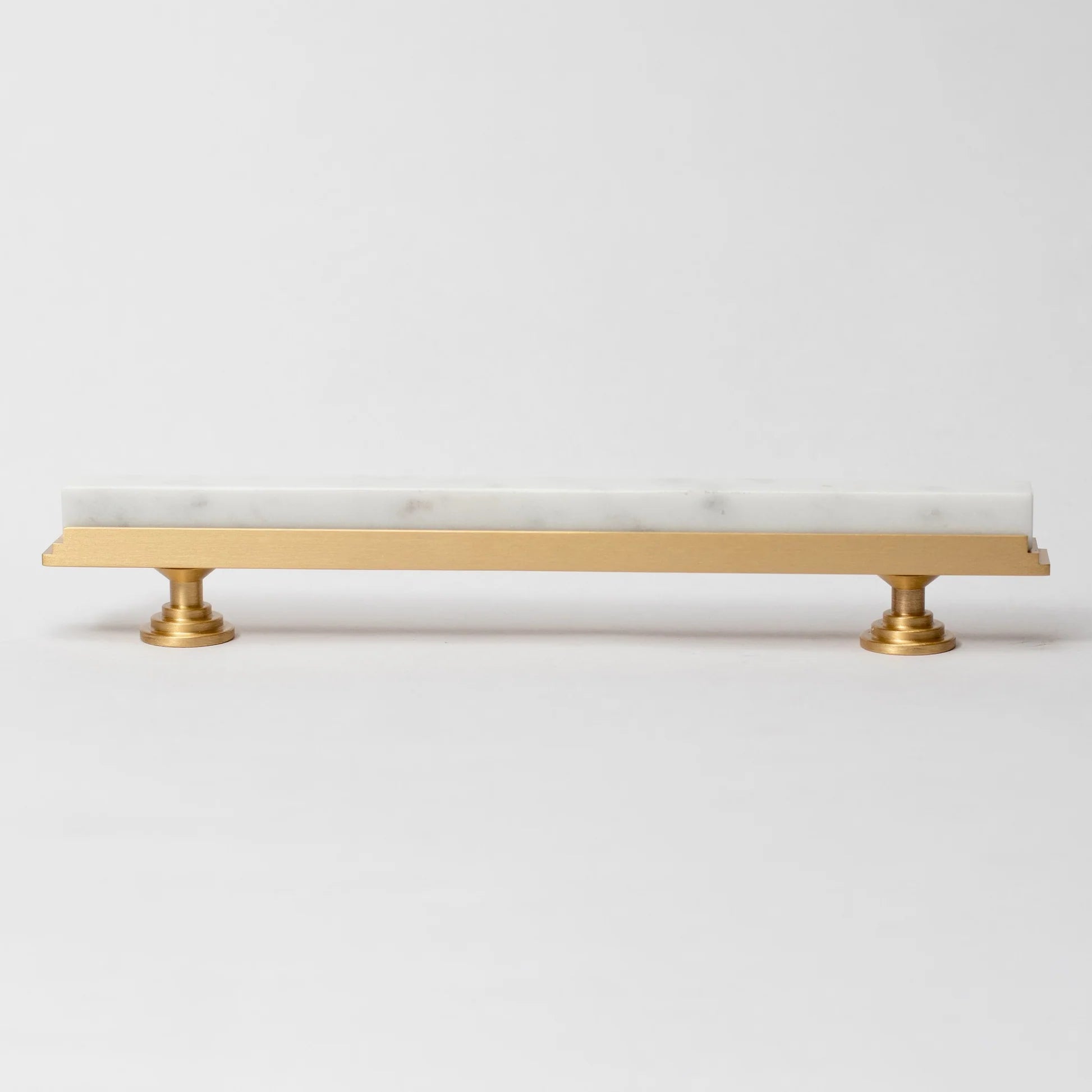 Karish Modern white marble and brass T-bar handle by Brass Essence, showcasing sleek design and polished finish.