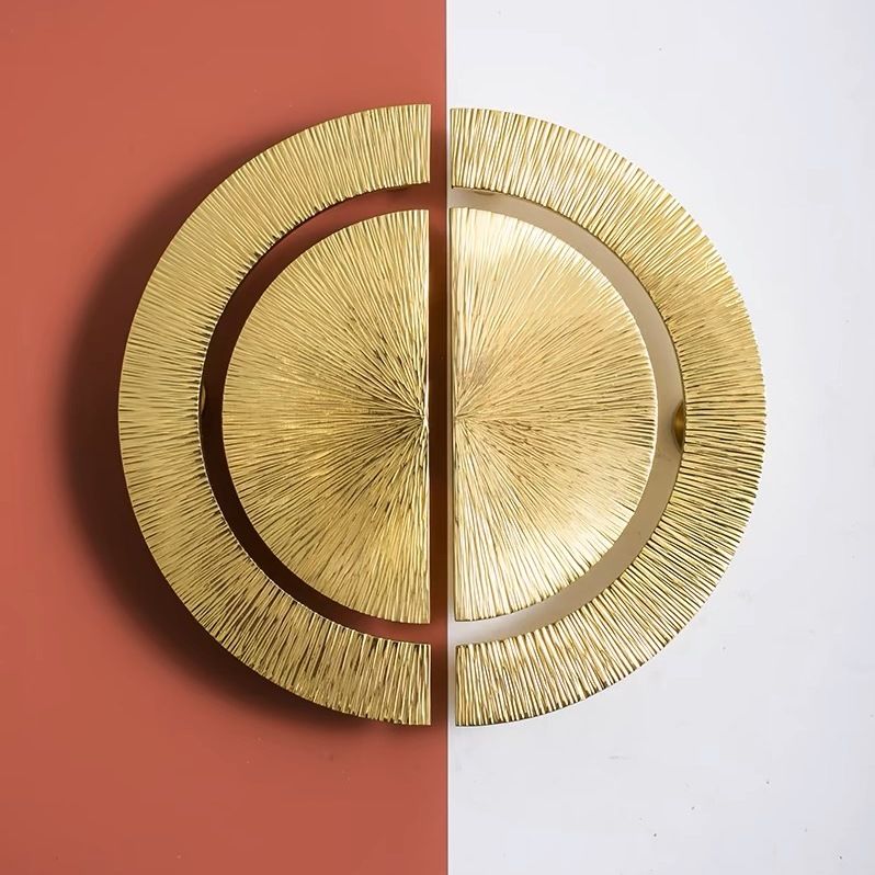 Gold circular wall art piece on a split red and white background