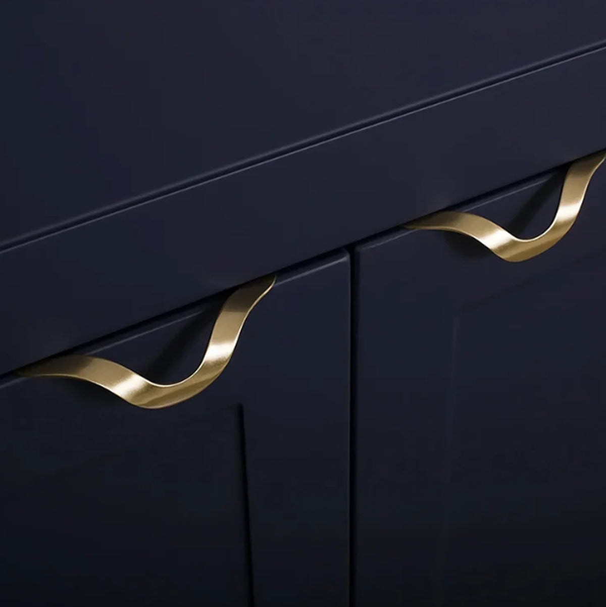 Front view of Brass Essence gold-tone wave kitchen drawer profile handle