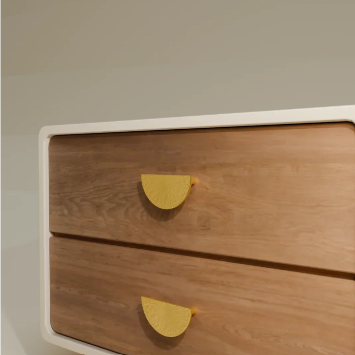 A close-up of a modern two-drawer wooden cabinet with a white frame and distinctive yellow semicircle drawer pulls, set against a plain light gray wall.